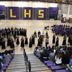 A view from atop the bleachers as choral groups and the band perform.